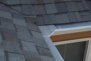 Roof edge detail showing shingles, drip edge, and flashing