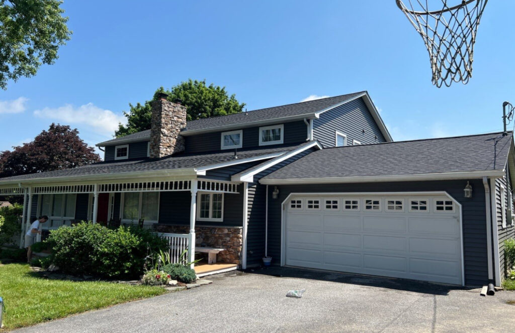 Residential home exterior with completed roof replacement and garage