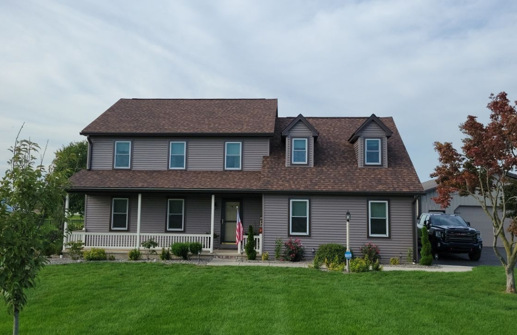 Suburban home showing completed roofing and siding project