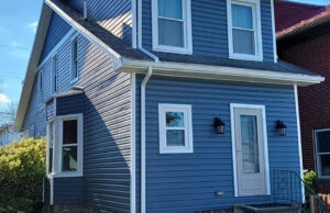 House with blue siding installed by Zimmerman's Roofing