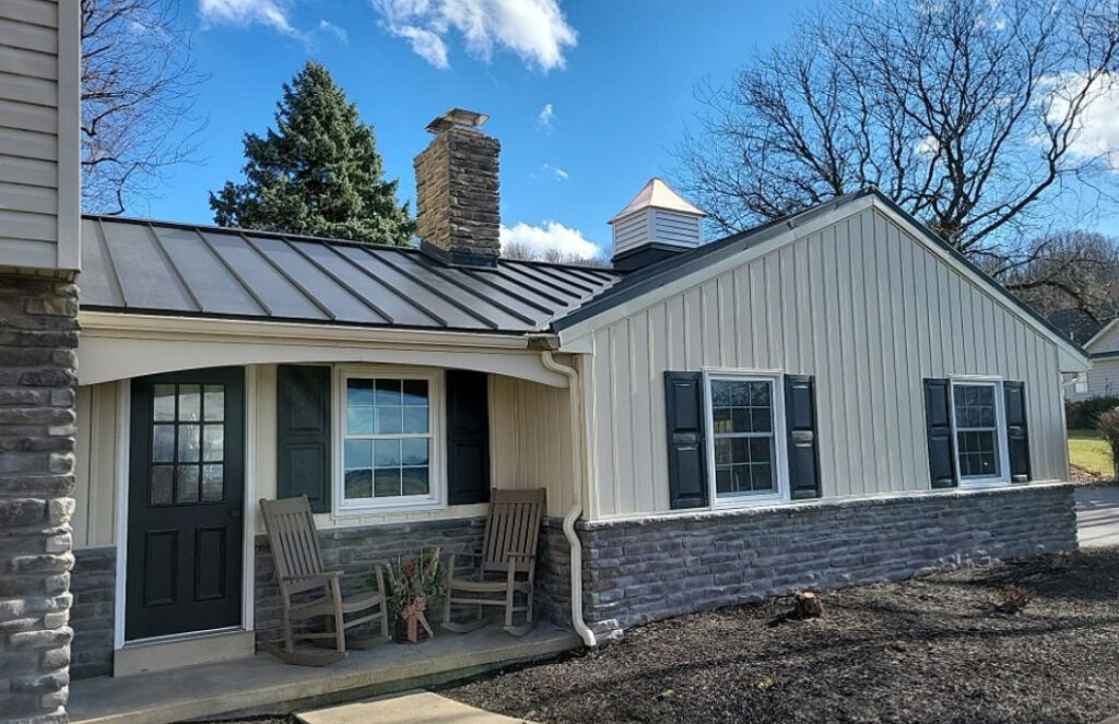 Ranch-style home with metal roof and stone accent exterior