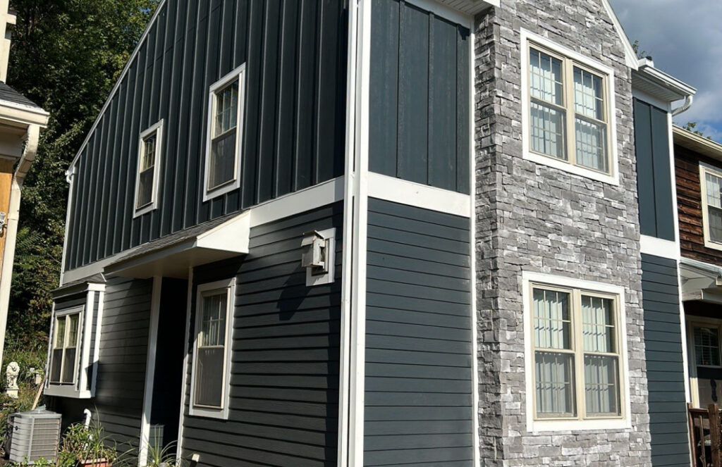 Exterior of a home with dark gray siding installed by Zimmerman's Roofing