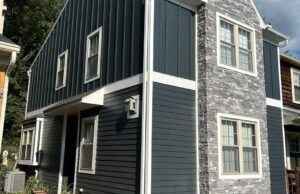 Exterior of a home with dark gray siding installed by Zimmerman's Roofing