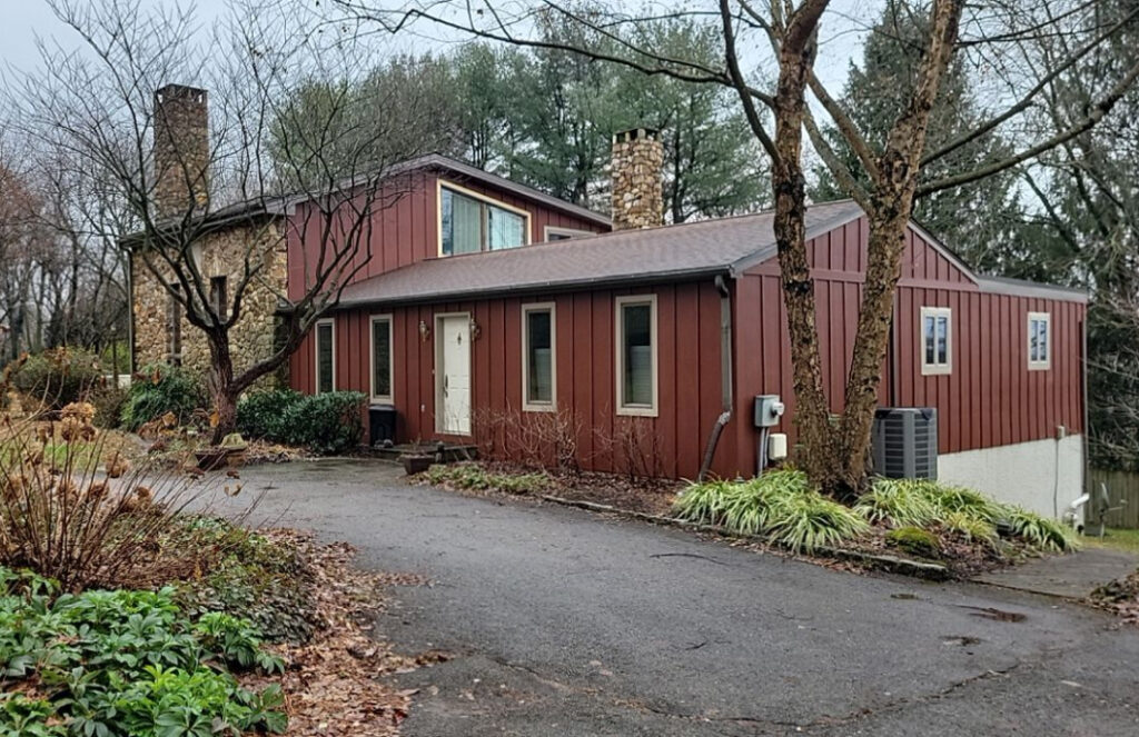 House with red siding installed by Zimmerman's Roofing