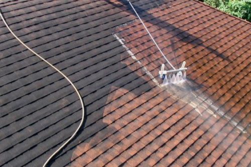 Low pressure water being use to clean a roof