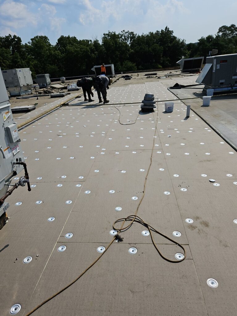 Zimmerman's Roofing team working on a flat roof installation